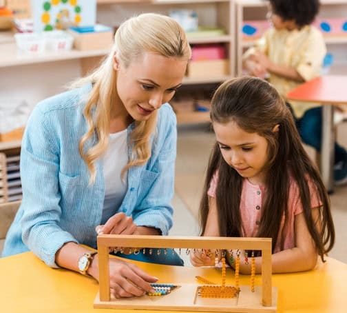 Therapist using learning tools with a child during autism therapy near Madison, CT