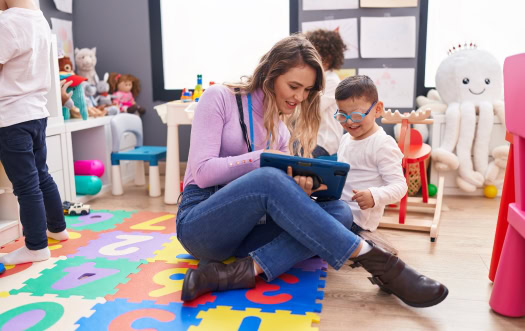 Autism Specialist near Guilford CT - 1 Autism specialist near Guilford, CT using a tablet for a one-on-one learning activity
